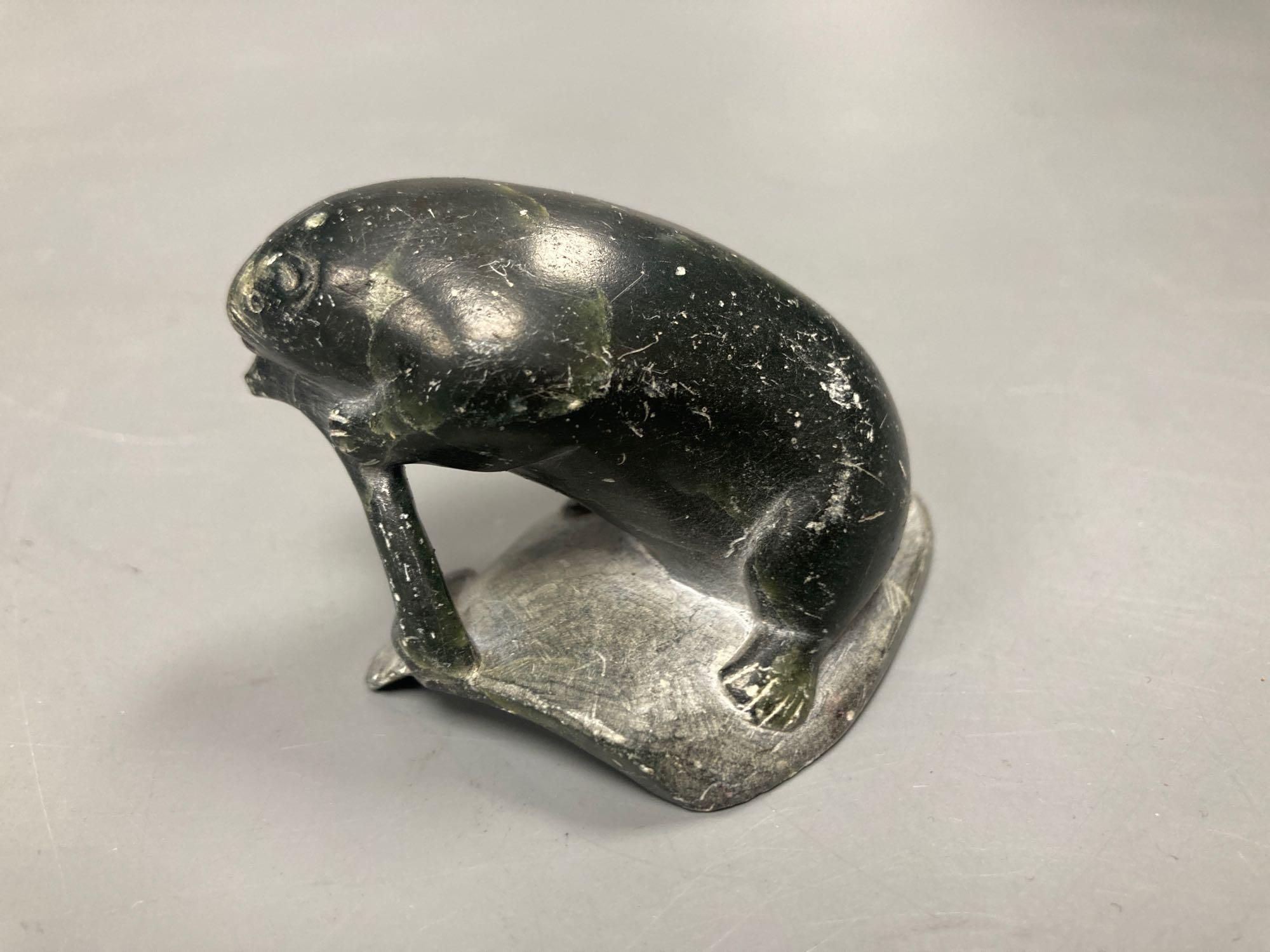 A carved inuit sculpture of a seal, signed Markossie SCP, 5cm high